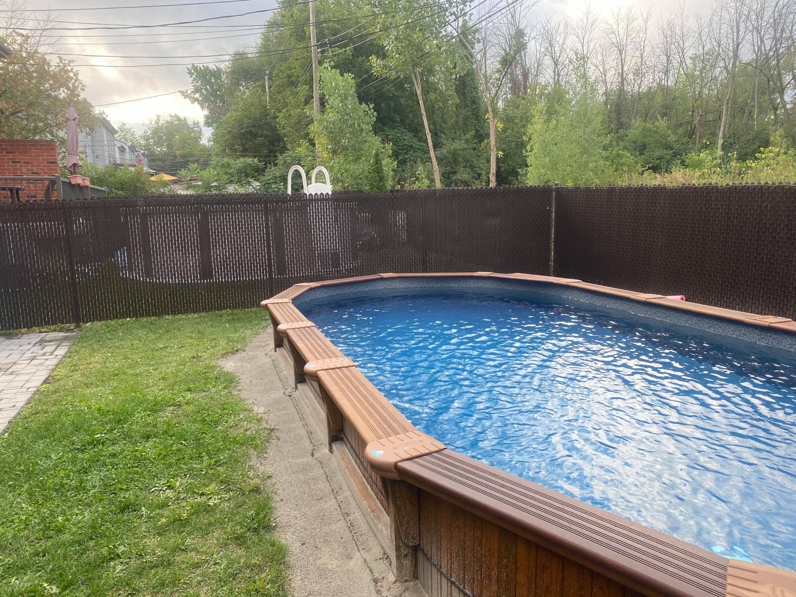 Finished pool installation, wider view with paver surround