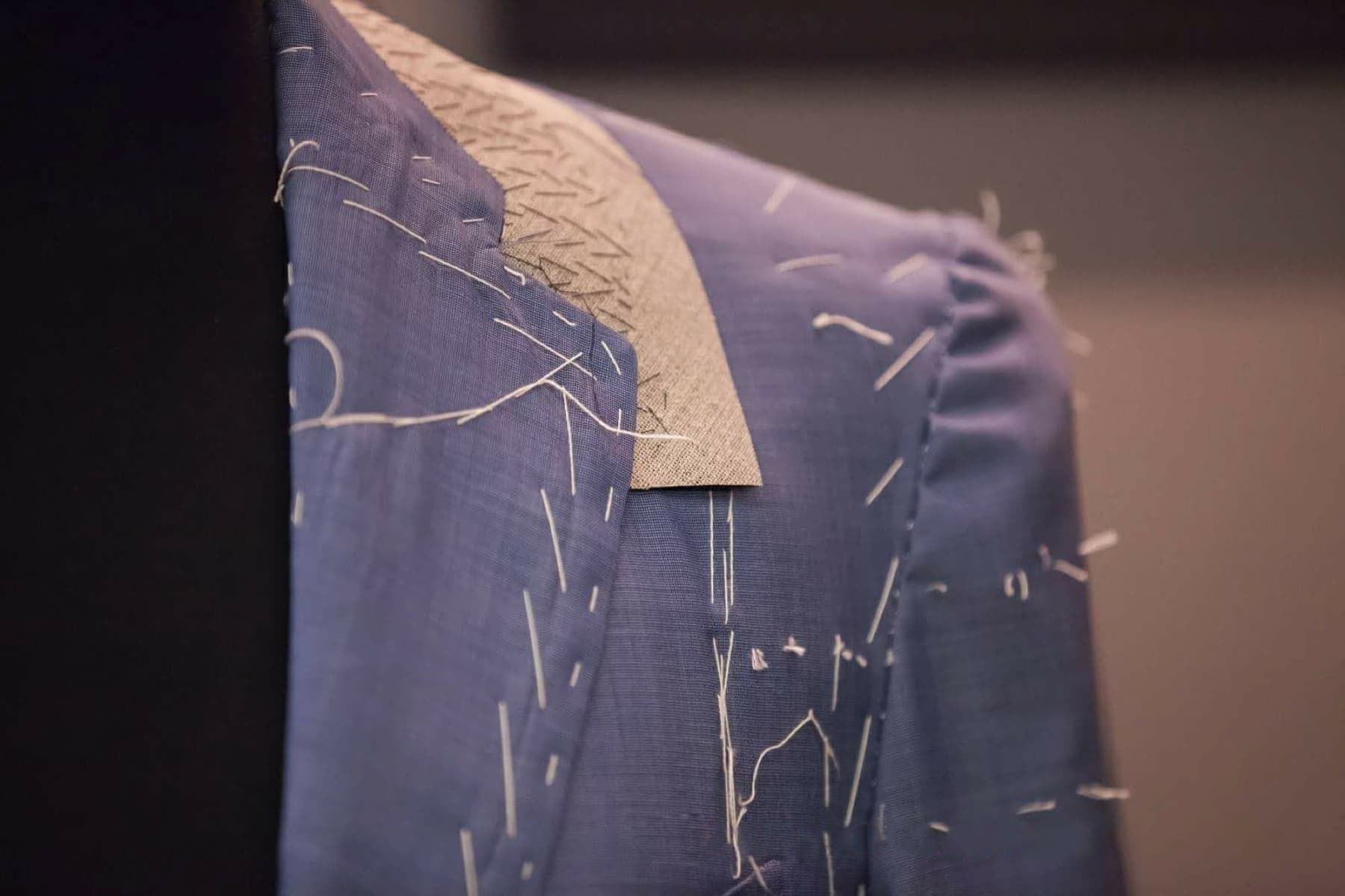 Bespoke jacket under construction, hand-basted canvas and shoulder seam before final assembly