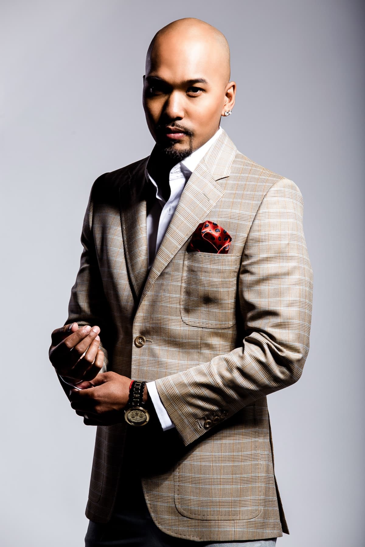 Studio portrait of a client in a custom plaid blazer with a red pocket square